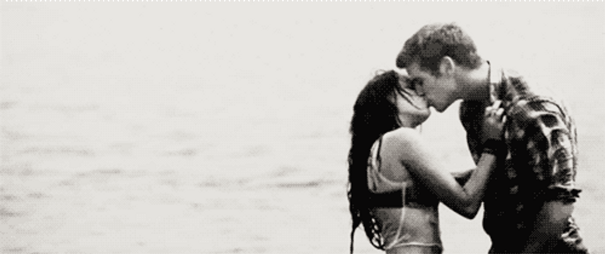 Partners Playfully And Passionate Kissing At The Beach GIF