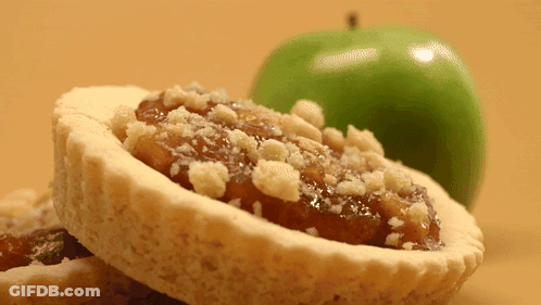 Pastry With Crumbs Next To Green Apple GIF