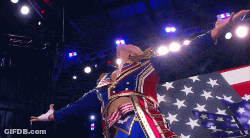 Patriotic Man Arms Outstretched In Front Of American Flag GIF