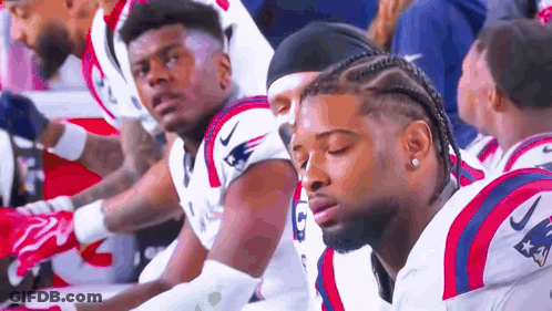 Patriots Football Players Sitting On Sidelines GIF