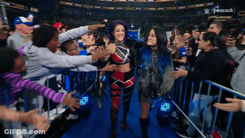 Peacock Logo Behind Crowd Of People GIF