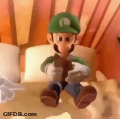 Peanut Mascot In Top Hat And Suit Standing In Front Of Building GIF
