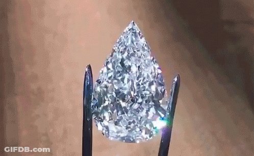 Pear Shaped Diamond Held By Tweezers GIF