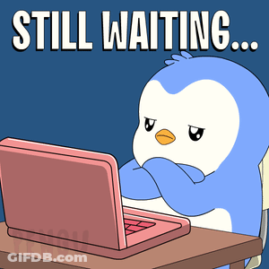 Penguin At Desk With Laptop Still Waiting GIF