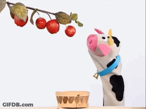 Penguin In Blue Scarf And Purple Bow In Front Of Apple Tree GIF