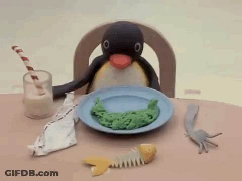 Penguin Sitting At Table With Food And Milk GIF