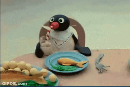 Penguin Sitting At Table With Food And Milkshake GIF