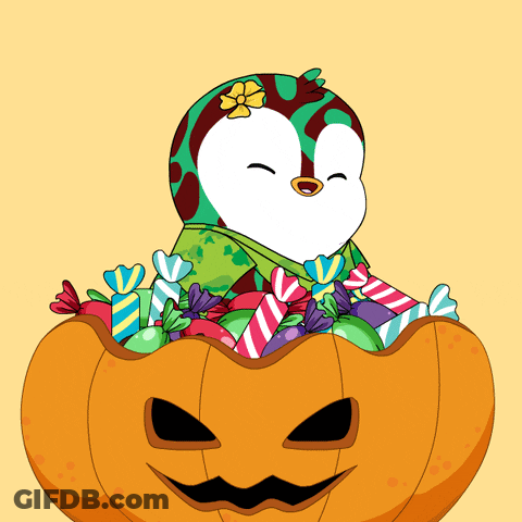Penguin Sitting In Halloween Pumpkin With Candy GIF