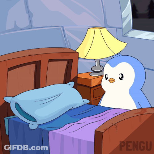 Penguin Sitting On Bed Next To Lamp GIF