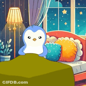 Penguin Sitting On Bed With Green Blanket GIF