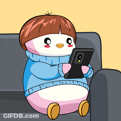 Penguin Sitting On Couch Looking At Phone GIF