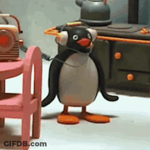 Penguin Wearing Headphones In Front Of Radio GIF