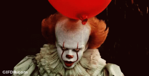 Pennywise The Clown From It Is Holding A Red Balloon On Top Of His Head . GIF