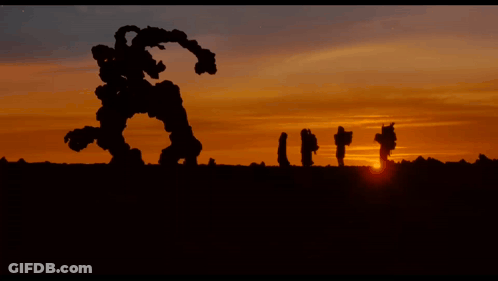 People And Robot In Field GIF