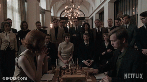 People Around Chess Board With Netflix Logo GIF
