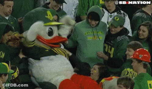 People Around Duck Mascot In Green Hoodie GIF