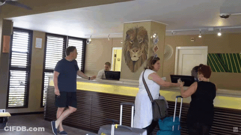 People At Counter With Lion Painting On Wall GIF