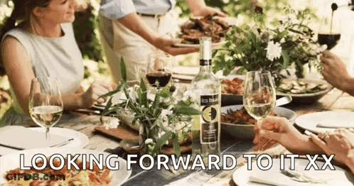 People At Table With Bottle Looking Forward To It XX GIF