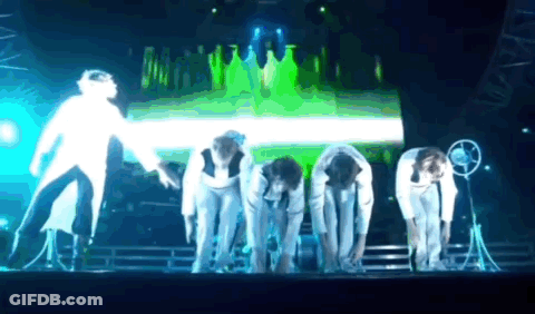 People Bending Over On Green Stage GIF
