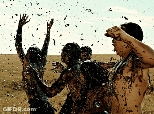 People Covered In Mud With Flying Birds GIF