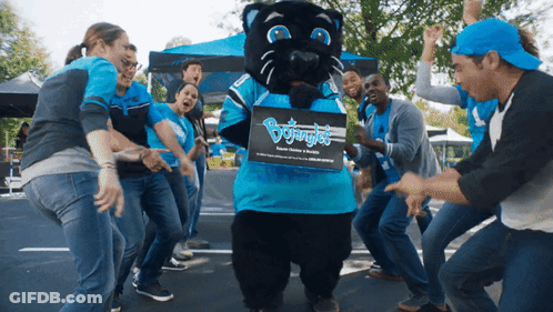 People Dancing Around Panther Mascot Holding Bojungle Box GIF