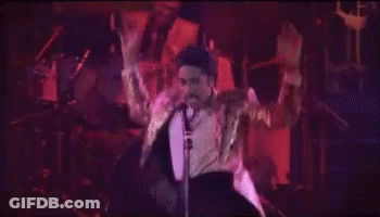 People Dancing In Dark Room In Front Of Neon Hotel Sign GIF