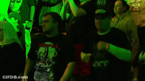 People Dancing In Dark Room With Green Lights GIF