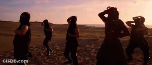 People Dancing In Desert At Sunset GIF