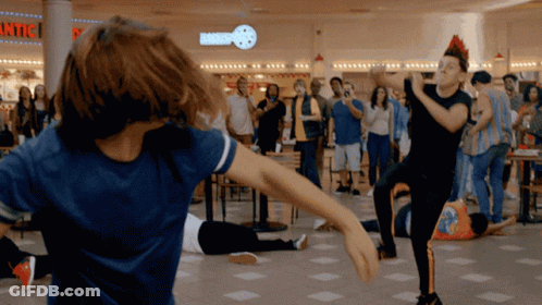 People Dancing In Front Of Bakery GIF