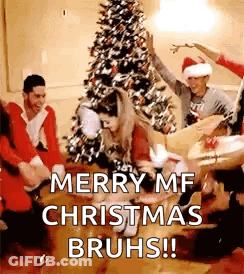 People Dancing In Front Of Christmas Tree GIF