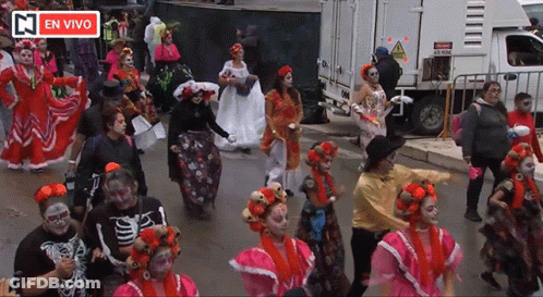 People Dancing In Front Of En Vivo Sign GIF