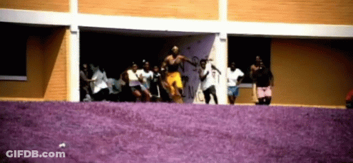 People Dancing In Front Of Graffiti Building GIF
