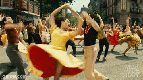 People Dancing In Front Of Hotel Sign GIF