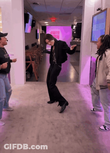 People Dancing In Front Of Jennifer Aniston Screen GIF