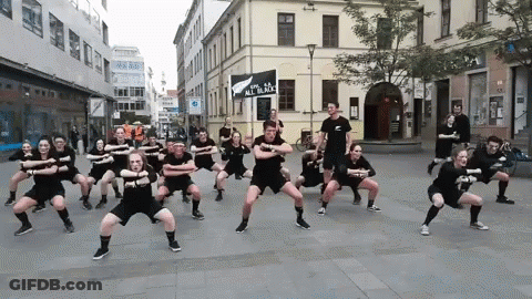 People Dancing In Front Of Sign All In Black GIF