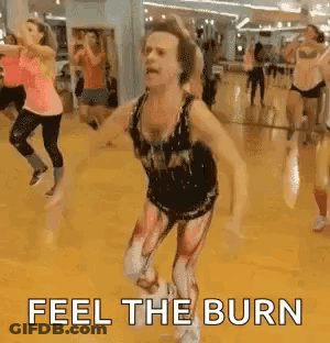 People Dancing In Gym With Feel The Burn Costume GIF
