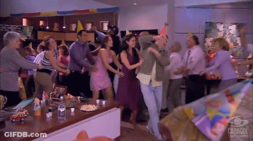 People Dancing In Room With Caragol TV Sign GIF