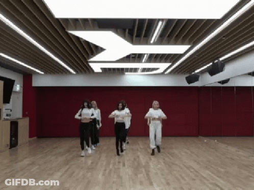 People Dancing In Room With Red Wall GIF