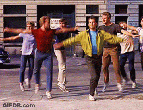 People Dancing On Sidewalk In Front Of Cart Sign GIF
