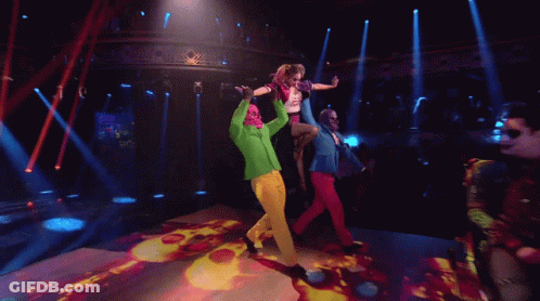People Dancing On Stage With Green Jacket GIF