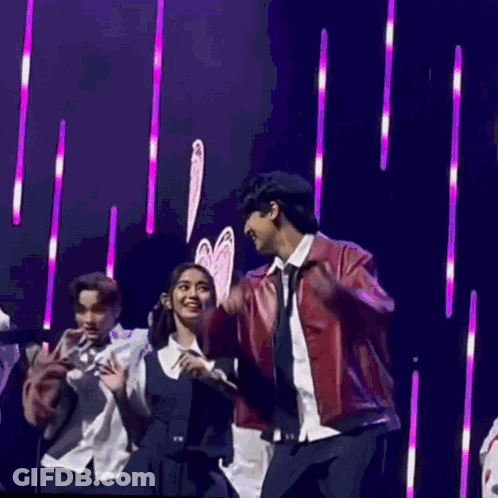 People Dancing On Stage With Purple Lights GIF