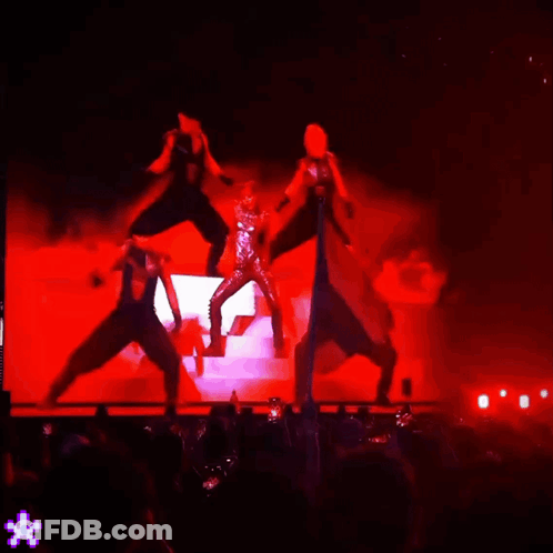 People Dancing On Stage With Red Lights GIF