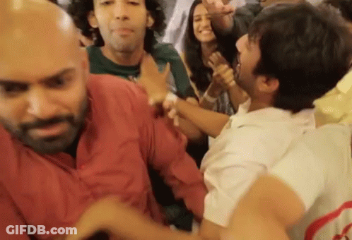 People Dancing With Man Holding Another's Arm GIF