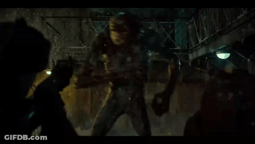 People Fighting Monster In Dark Room GIF