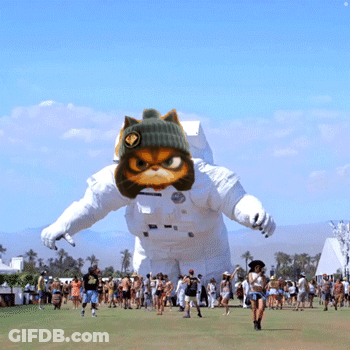 People Gathered Around Inflatable Astronaut Cat GIF
