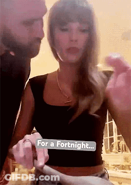 People Gathered Around Kissing Couple GIF