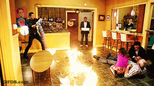 People Gathered In Living Room With Fire GIF