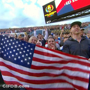 People Holding American Flag With Scoreboard Saying Ed GIF
