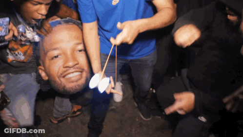 People Holding Man's Head In Air GIF