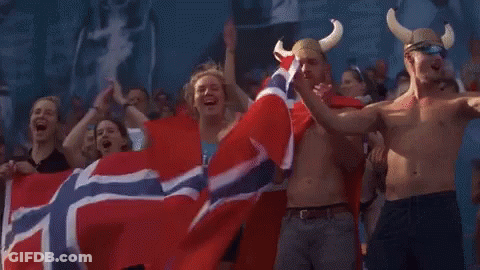 People Holding Norwegian Flag And Wearing Viking Hats GIF